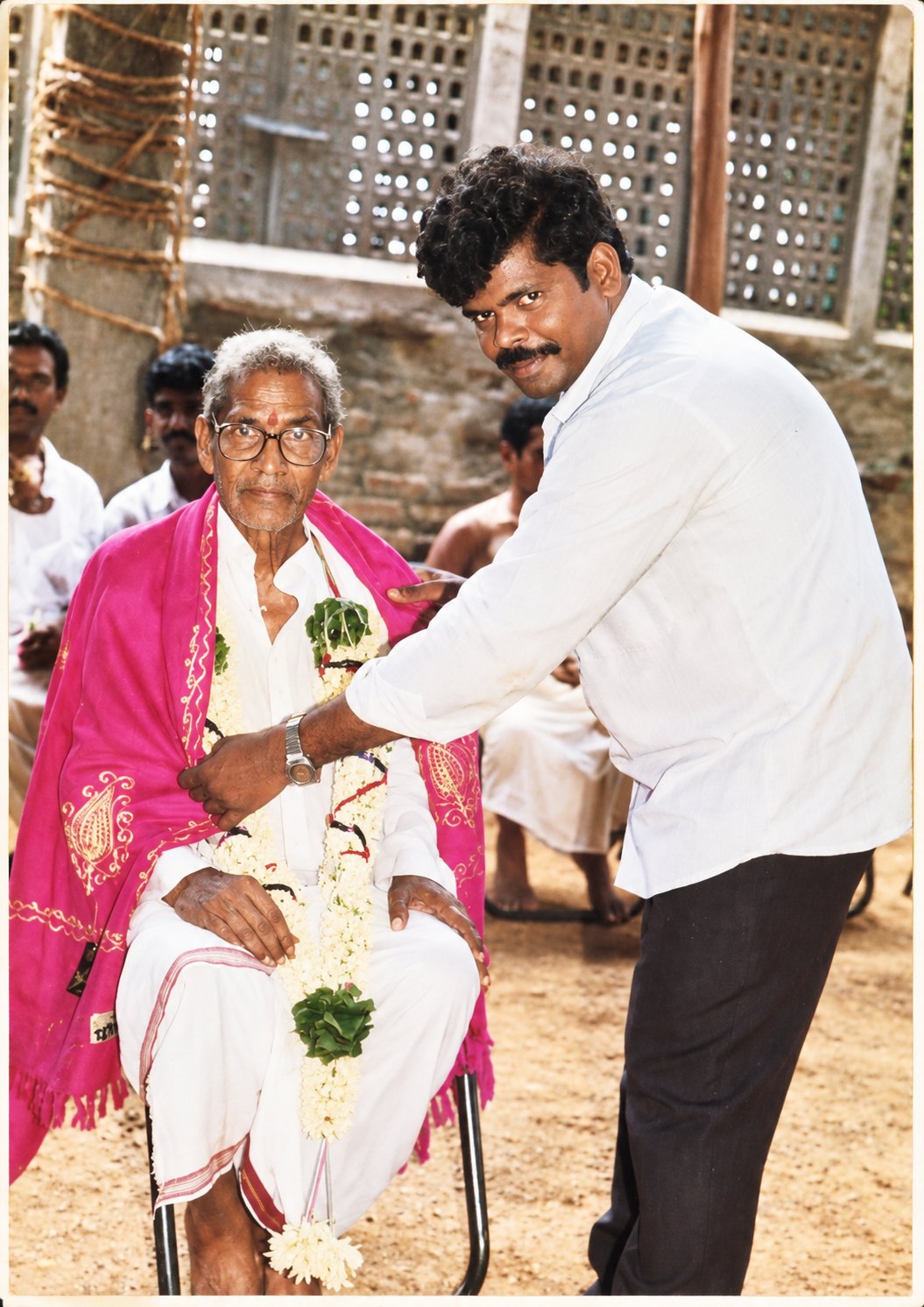 Katuri felicitating Ancha with a garland